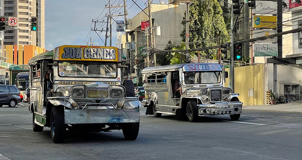 two jeepneys on the road side by side