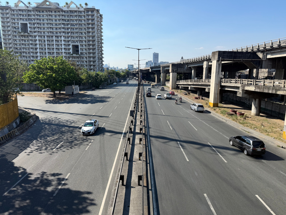 Manila highway with light traffic on a sunny day, picture from above