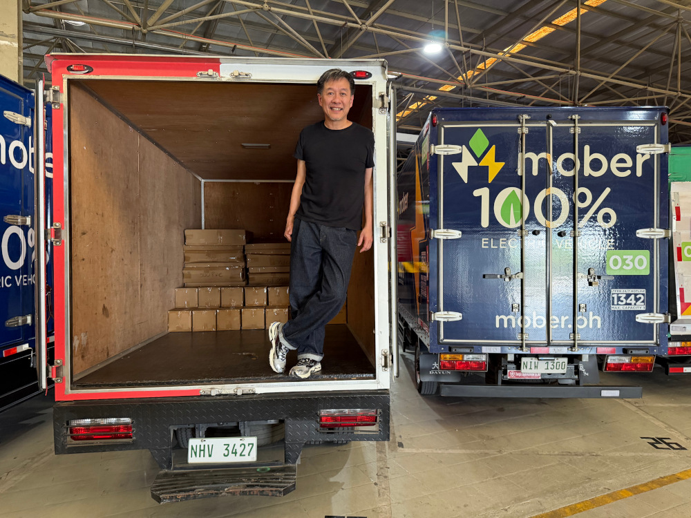 Mober CEO Dennis Ng stands inside a truck at the firm's Pasay HQ